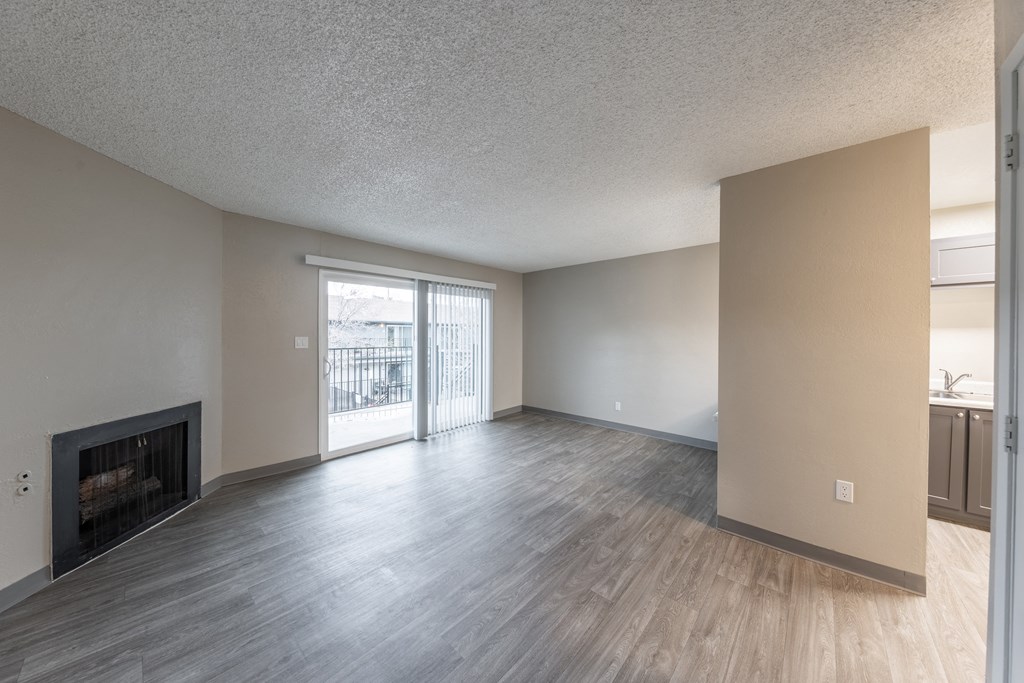 a living room with a fireplace and a balcony