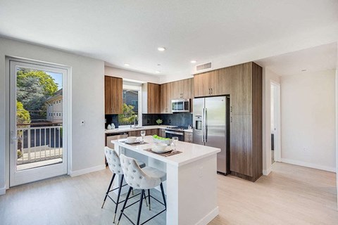 a kitchen with a large center island next to a sliding glass door