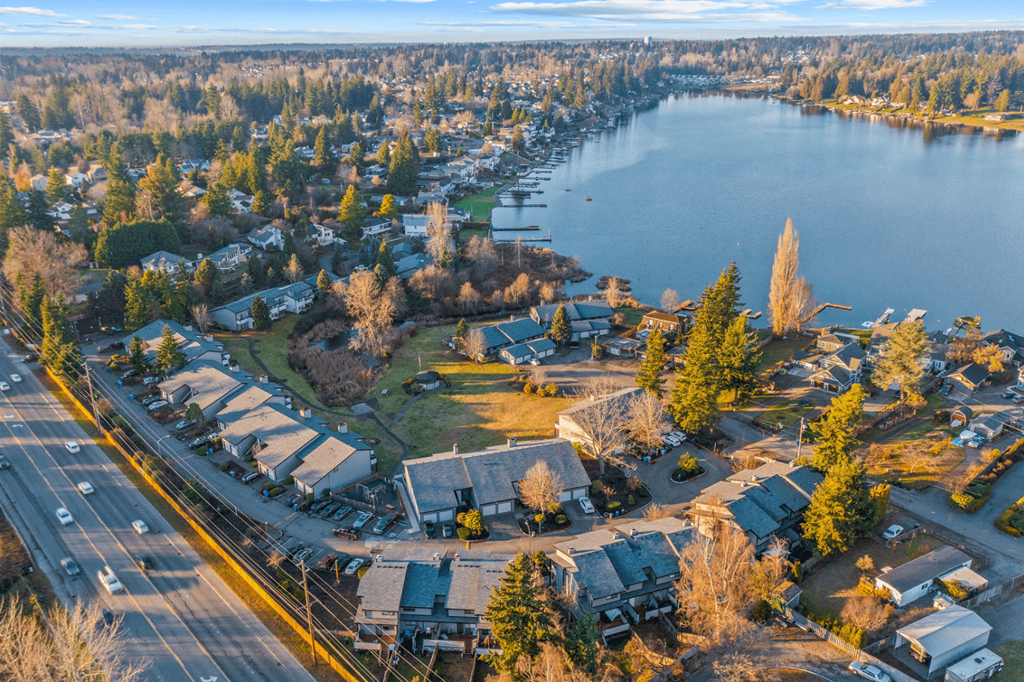 Kent Apartments - Township Lake Meridian - Bird's Eye View of Community Surrounded by Lush Landscaping and a Lake