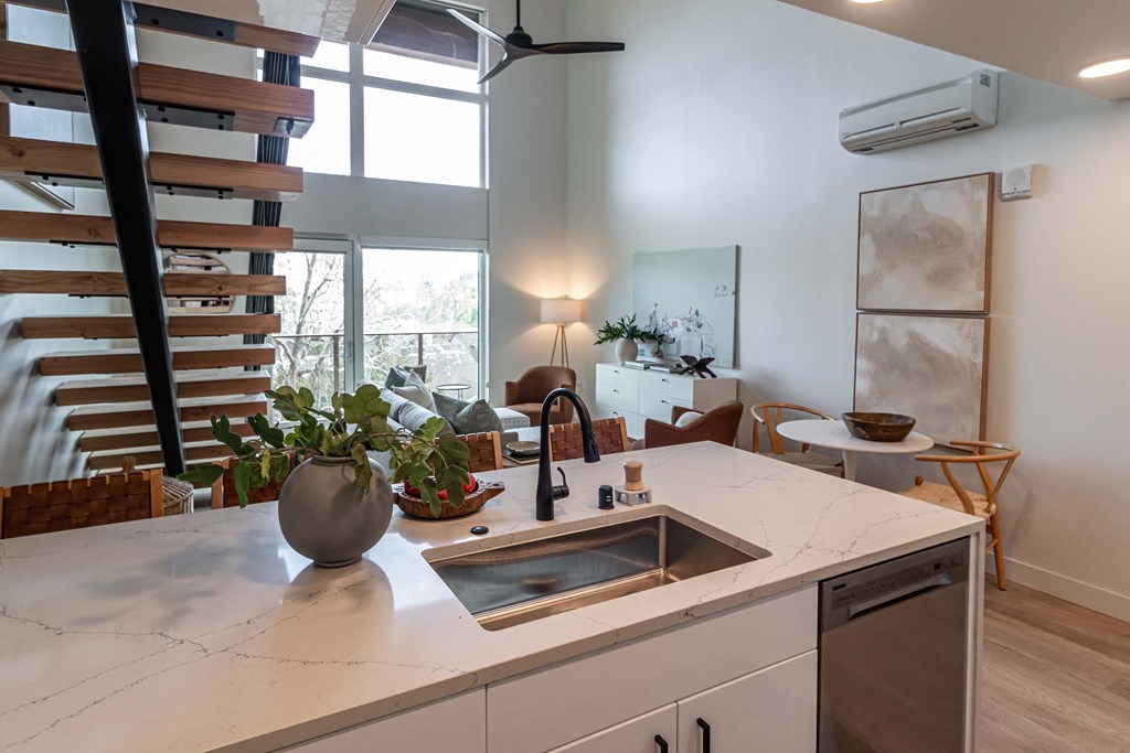 a kitchen with a sink and a counter top in a living room