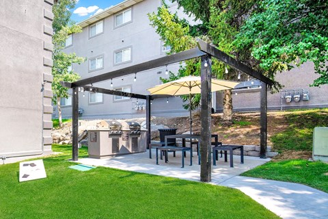 a patio with a table and chairs under a canopy at Mountain Run Apartments, Orem, 84058
