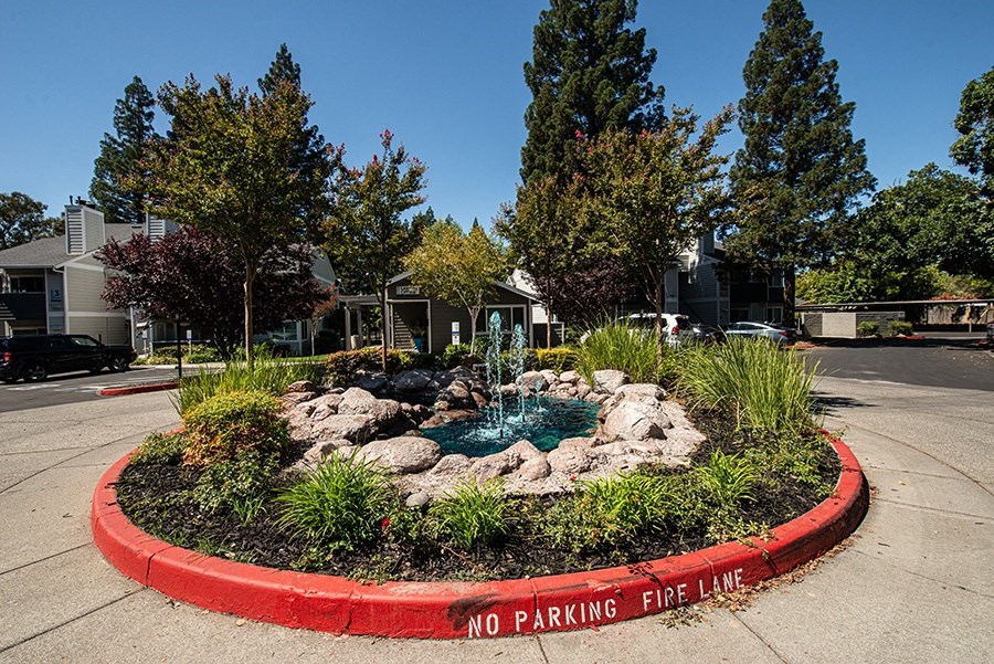 a fountain in the middle of a no parking fire pit