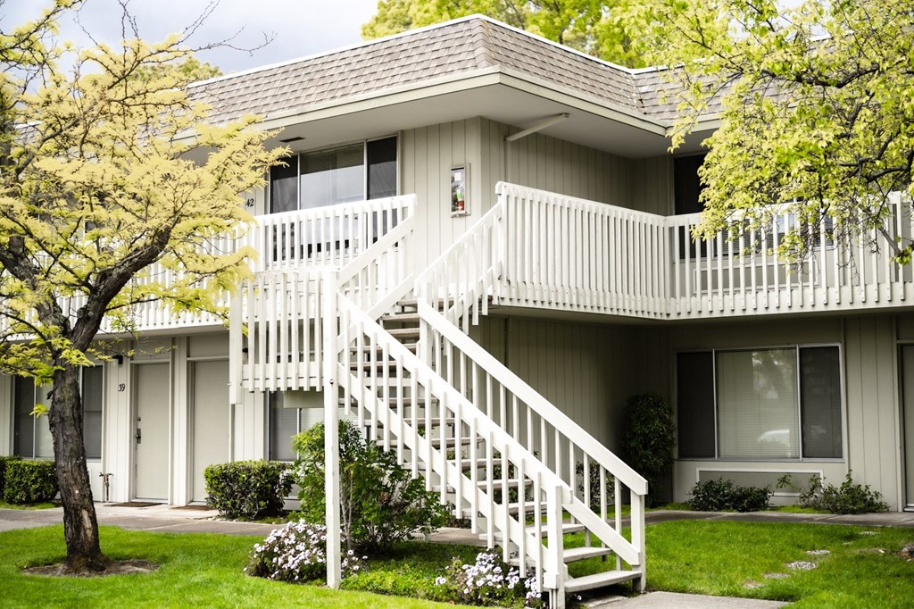 an exterior view of an apartment building with a white staircase an exterior view of an apartment building with a white staircase at OTAVON APARTMENTS, Novato California