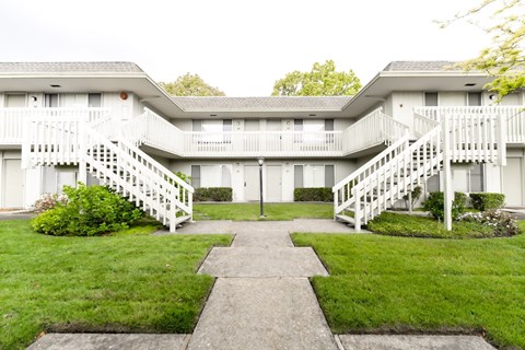Building exterior with a beautiful lawn near the sidewalk at OTAVON APARTMENTS, California