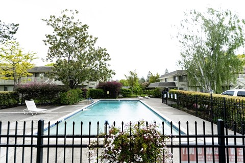 a swimming pool with a fence in front of it at OTAVON APARTMENTS, California, 94947