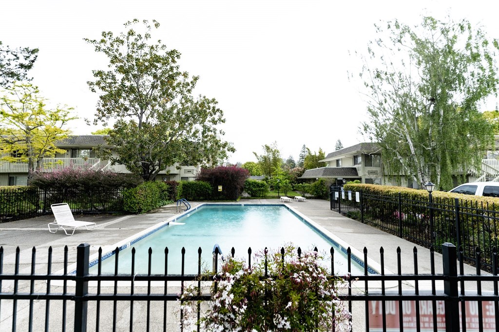 a swimming pool with a fence in front of it a swimming pool with a fence in front of it at OTAVON APARTMENTS, California, 94947