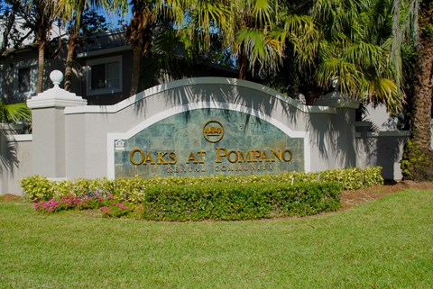 Oaks at Pompano community exterior and signage