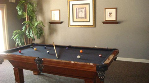a pool table with balls on it in a room
