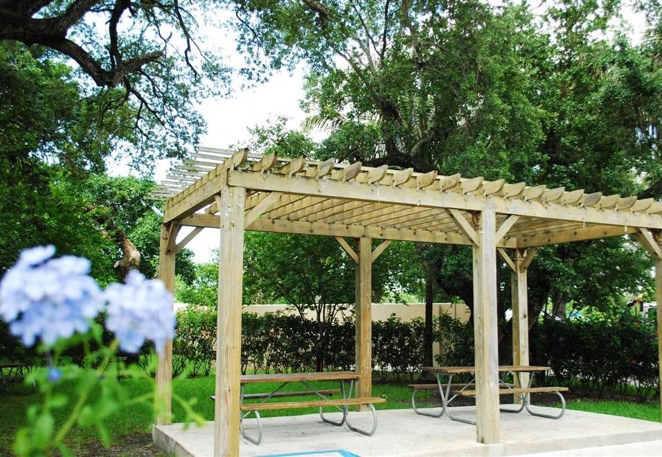 Picnic benches near grass at Bay Winds, Miami, FL