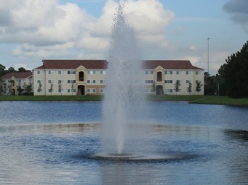 Mission Pointe apartments lake views and community exterior with fountain - Photo Gallery 2