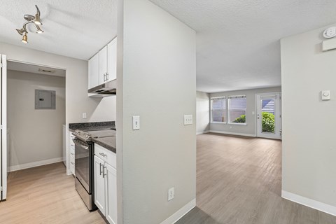 A kitchen with a stove top oven and a refrigerator.
