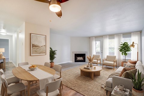 A living room with a fireplace, a dining table, and a couch.