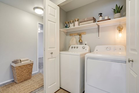 A small laundry room with a washer and dryer.