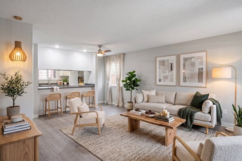 A living room with a sofa, chairs, and a coffee table.