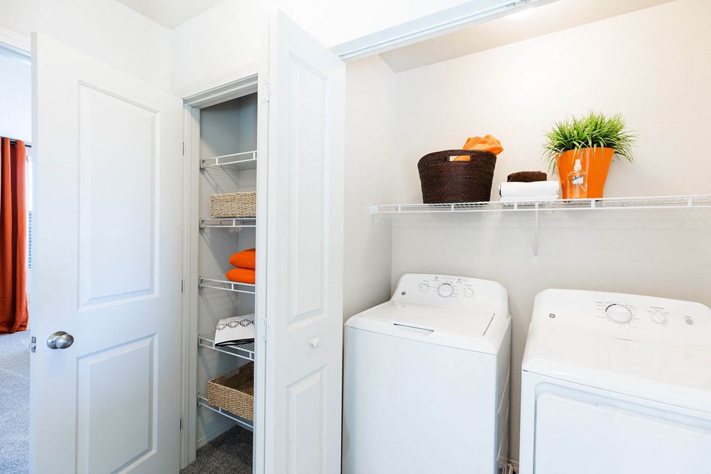 a small laundry room with a washer and dryer and a closet at EVERETT APARTMENT HOMES, Las Vegas, NV, 89113