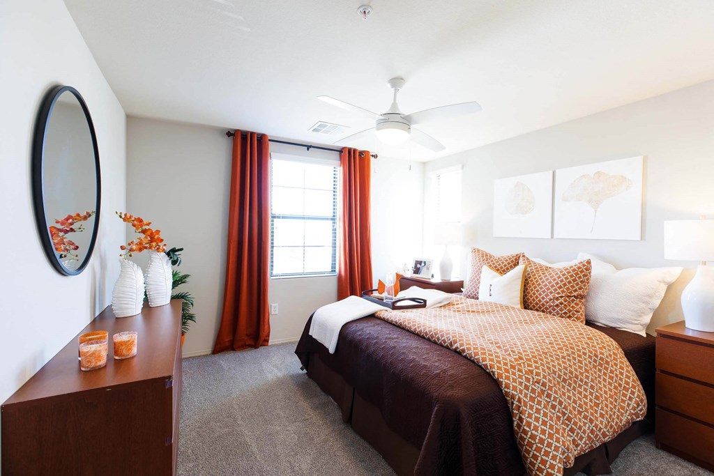 a bedroom with a bed and a dresser and a ceiling fan at EVERETT APARTMENT HOMES, Las Vegas, NV, 89113