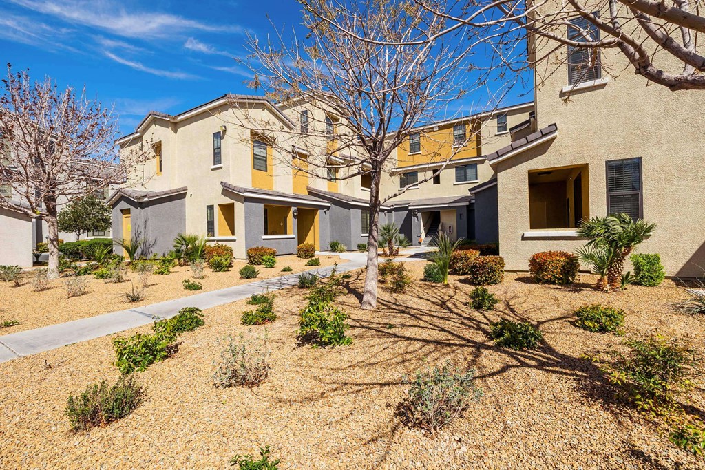 the front of a house with a yard and a sidewalk at EVERETT APARTMENT HOMES, Las Vegas, 89113