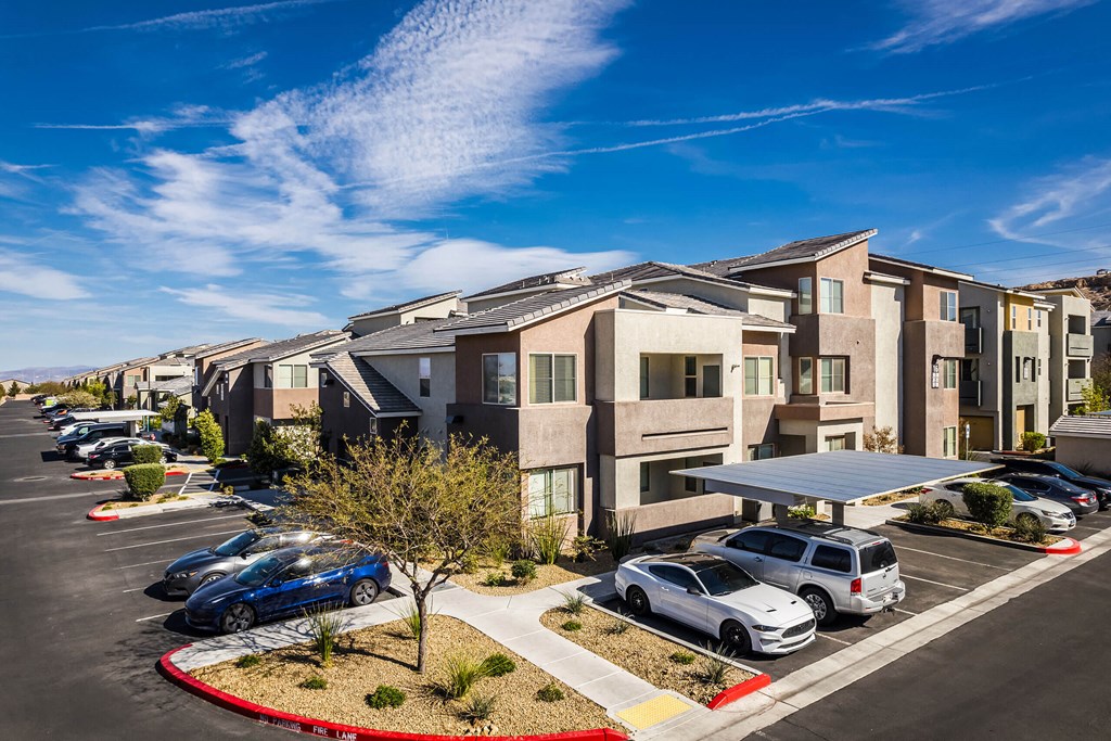 A row of apartment buildings at Everett and a cars in a parking lot. at EVERETT APARTMENT HOMES, Las Vegas, NV, 89113