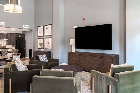 A living room with a black screen on the wall.