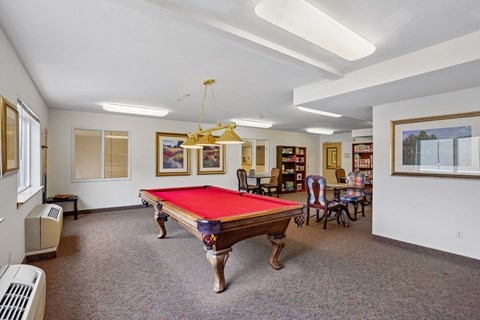 A room with a pool table and a bookshelf at Vintage at Burien, Burien, WA