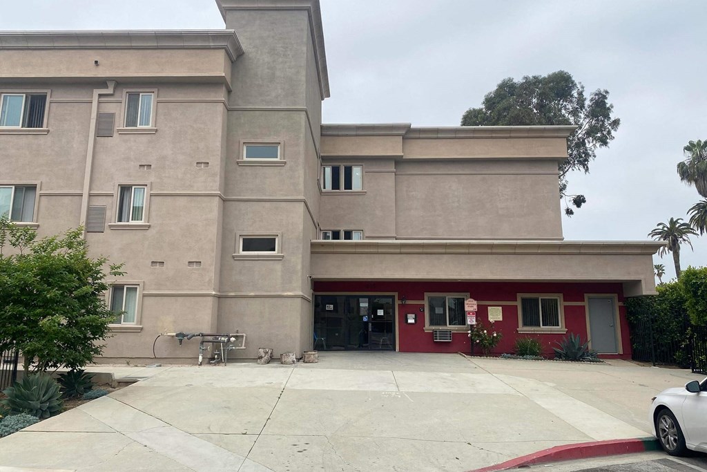 the front of a building with a driveway and a bike parked in front