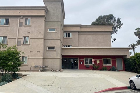 the front of a building with a driveway and a bike parked in front