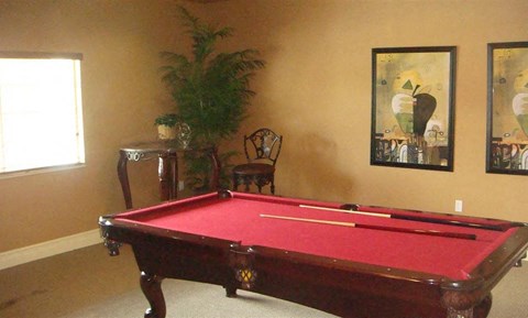 a red pool table in a living room