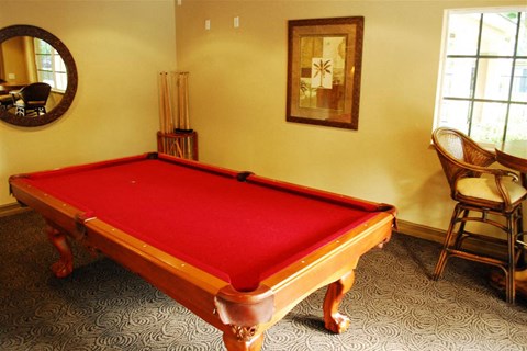 a pool table with a red cloth on it