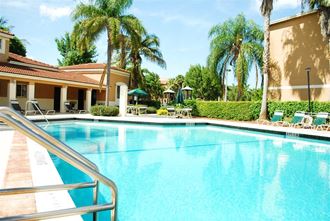 Pool with lounge chairs Hidden Cove Apartments in Miami Florida - Photo Gallery