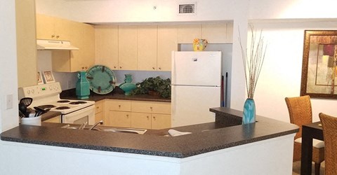 a kitchen with a counter top and a refrigerator