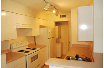 Marbrisa Apartments kitchen with white appliances and lots of cabinetry