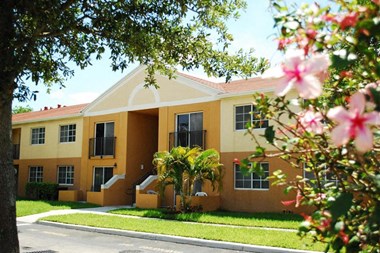 Marbrisa Apartments community exterior and walkways with palm trees