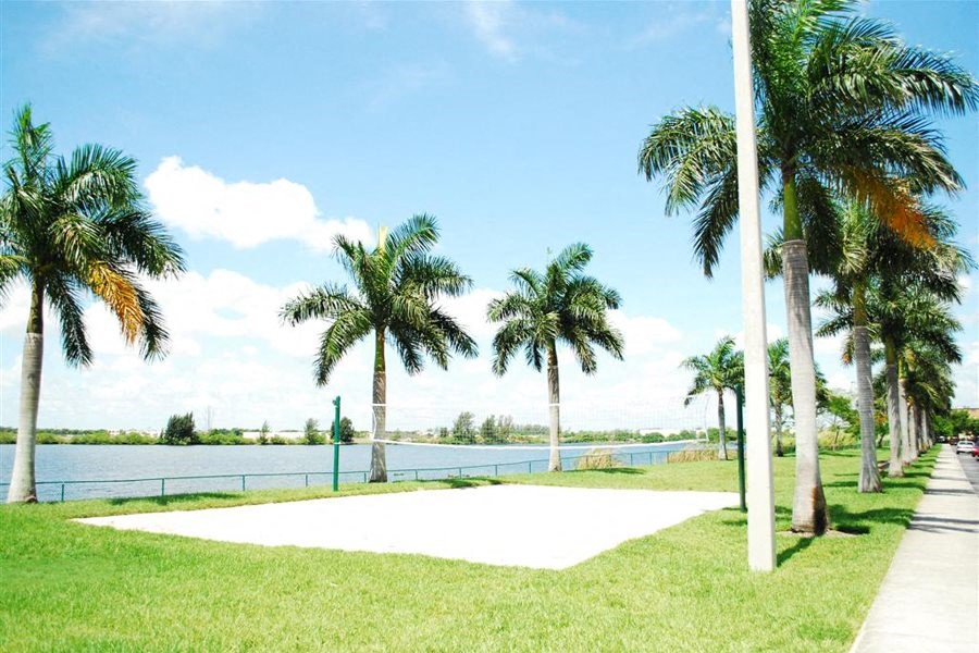 Marbrisa Apartments volley ball area with palm trees