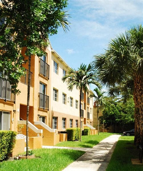 Marbrisa Apartments community exterior and walkways with palm trees