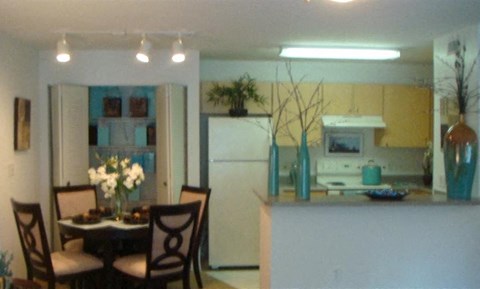 a kitchen and dining room with a table and chairs