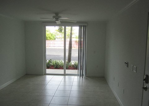 an empty living room with a sliding glass door