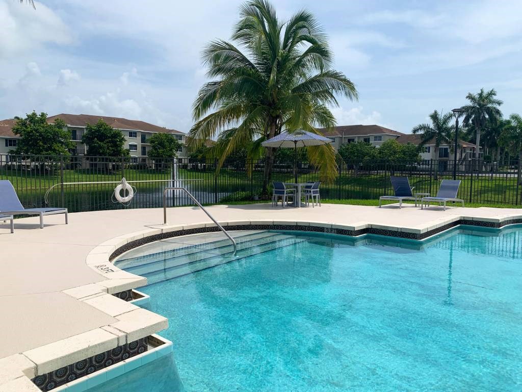 Pool and lounge chairs at Tuscany Place Apartments, Homestead , FL