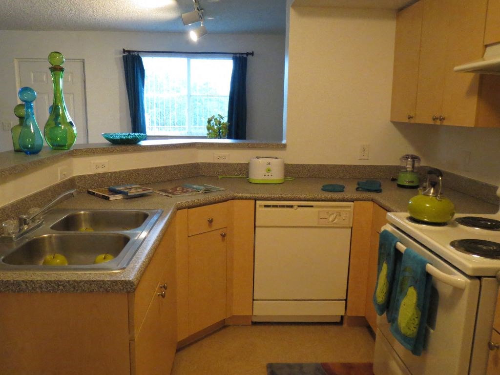 home kitchen with white appliances at Tuscany Place Apartments, Florida