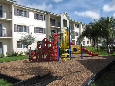 a playground in front of an apartment building