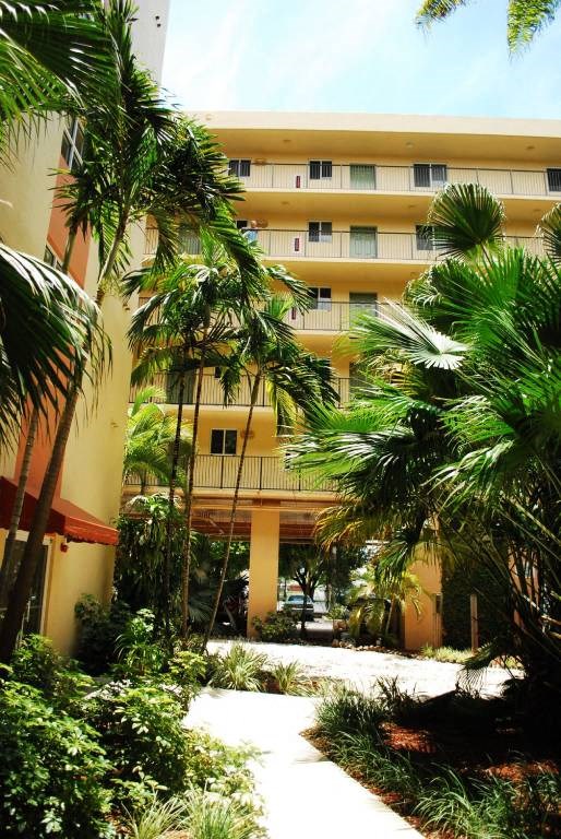 community exterior with palm trees and walk ways at Villa Hermosa, Miami, FL