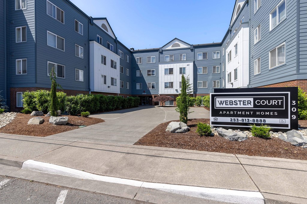 a building with a sign that reads western court apartment homes