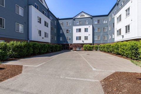 an empty parking lot in front of an apartment building at Webster Court Senior Apartments, Kent, 98032