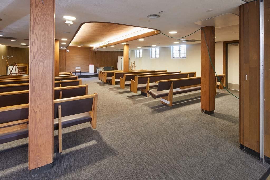 a large room with many wooden pews in it at MILEPOST 5 Apartments, PORTLAND