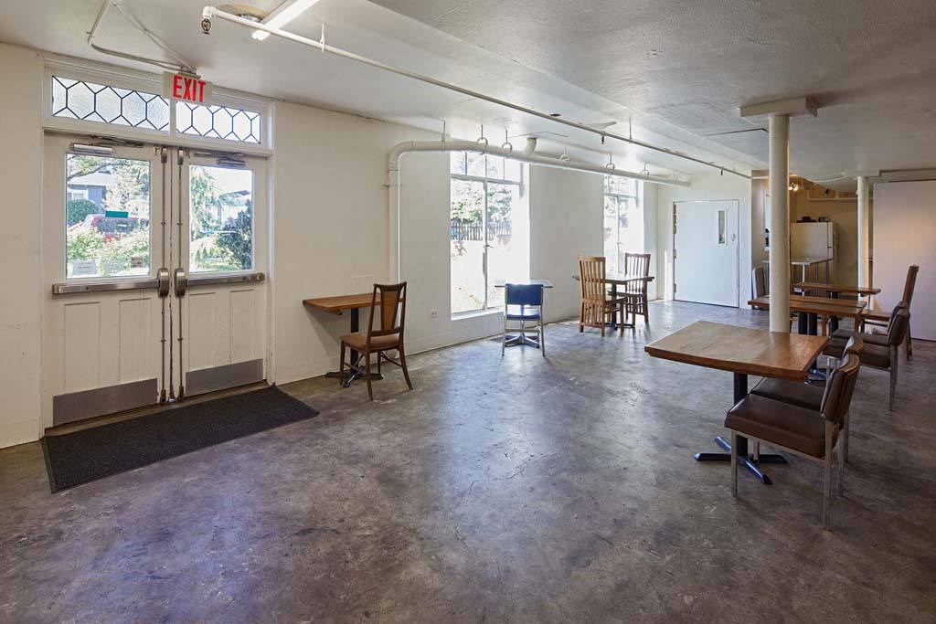 a large room with tables and chairs at MILEPOST 5 Apartments, PORTLAND, OR