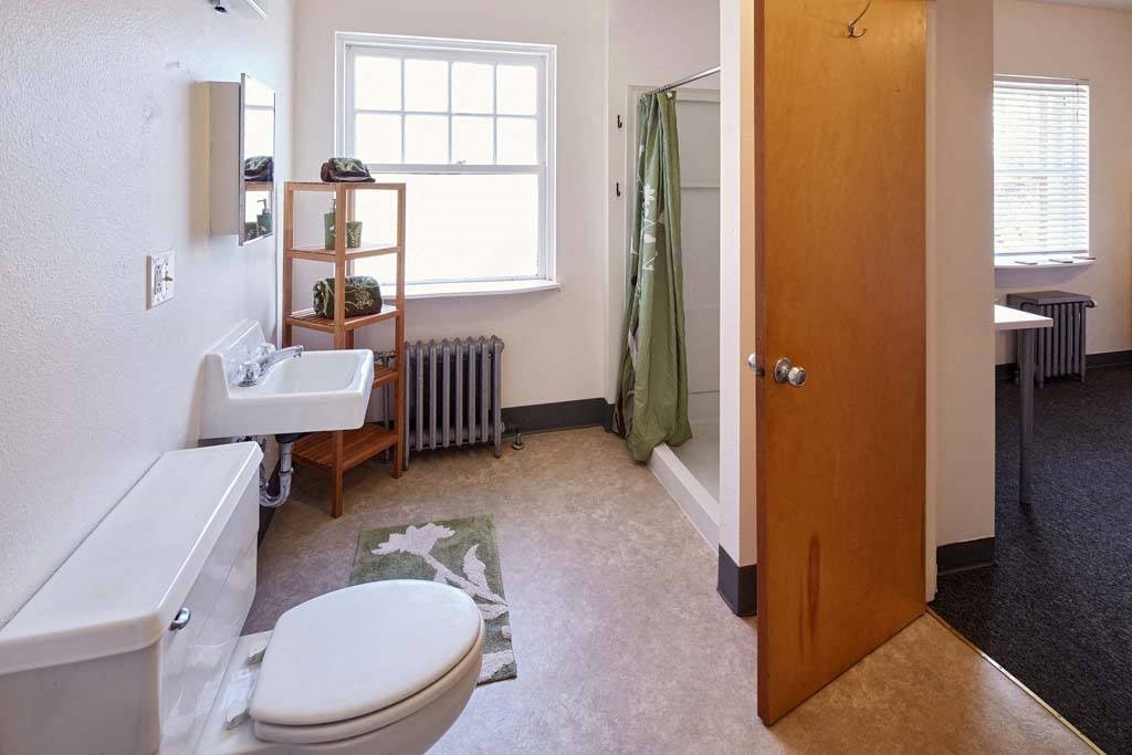 a bathroom with a toilet sink and a shower at MILEPOST 5 Apartments, PORTLAND, OR