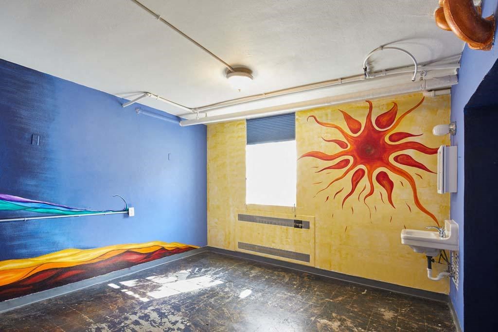 a mural of a sun on a wall in a room at MILEPOST 5 Apartments, PORTLAND Oregon