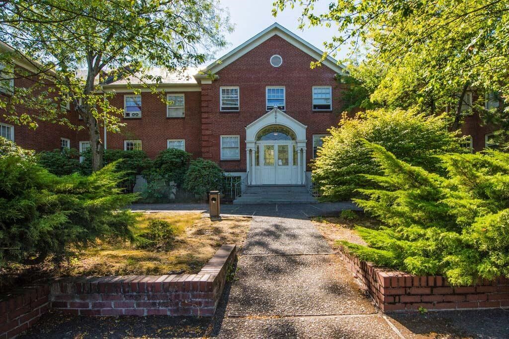 a large brick house with a white door at MILEPOST 5 Apartments, PORTLAND, OR