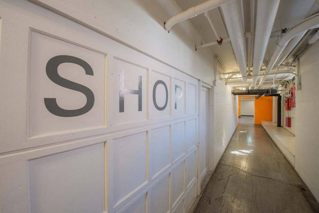 a wall with a sign that says shop on it at MILEPOST 5 Apartments, Oregon, 97213