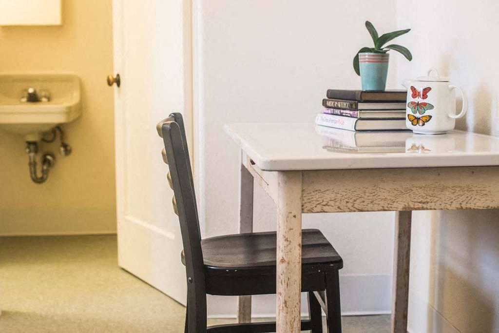 a table with a book and a cup on top of it at MILEPOST 5 Apartments, PORTLAND, 97213