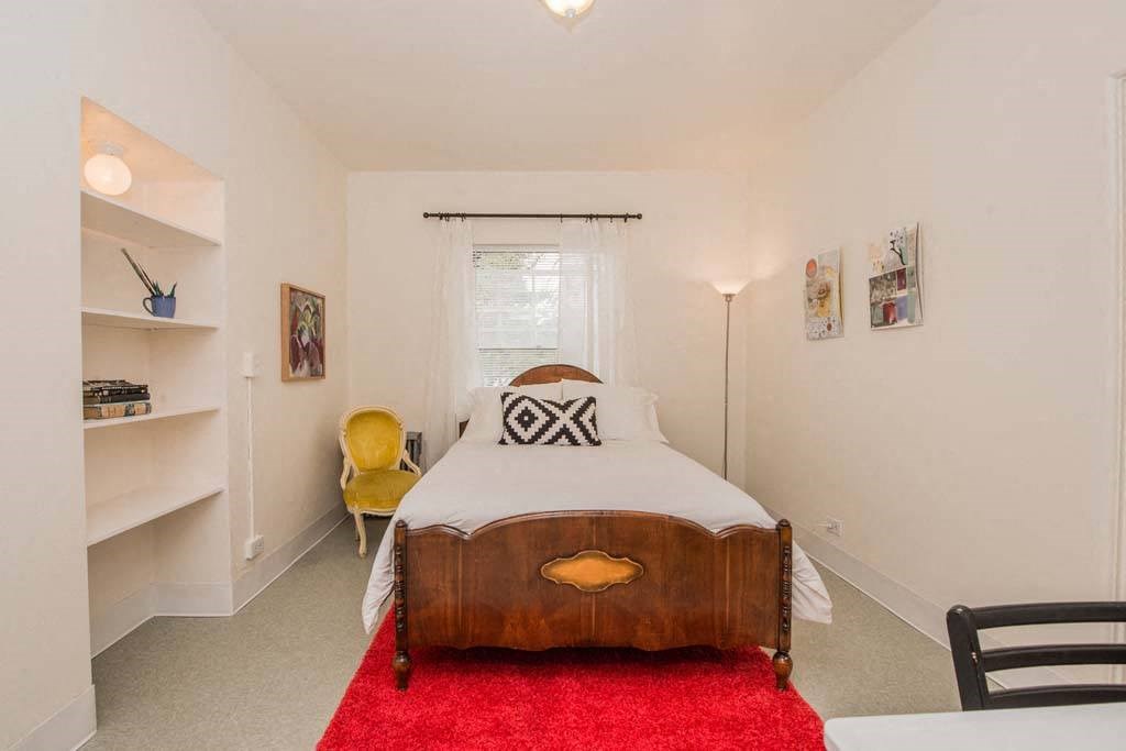 a bedroom with a bed and a window at MILEPOST 5 Apartments, PORTLAND, OR
